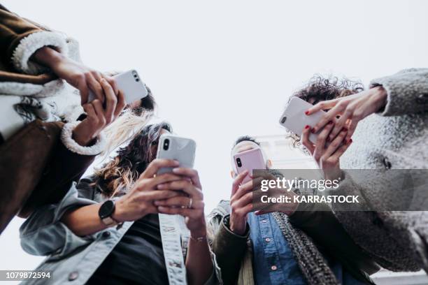 group of friends in the street with smartphone - addiction stock pictures, royalty-free photos & images