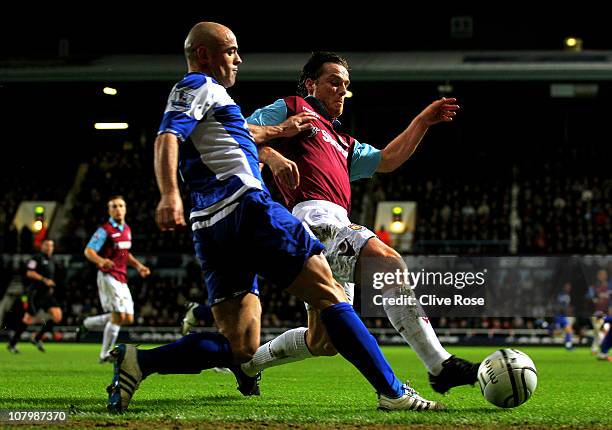 Scott Parker of West Ham wins the ball ahead of Stephen Carr of Birmingham during the Carling Cup Semi Final first leg match between West Ham United...