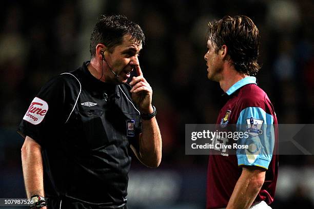 Referee Phil Dowd speaks with Scott Parker of West Ham during the Carling Cup Semi Final first leg match between West Ham United and Birmingham City...