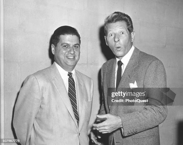 American actor and comedian Danny Kaye makes a surprised face as he poses with an unidentified White house staffer, August 26, 1956.