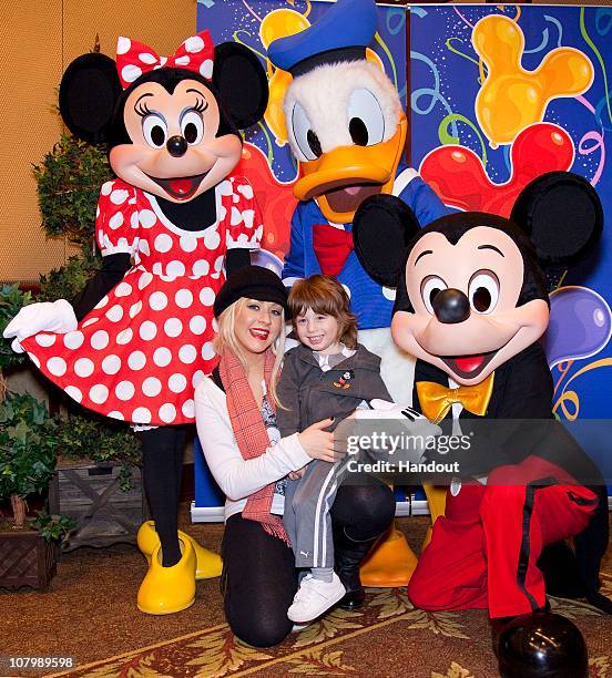 In this handout photo provided by Disney, Christina Aguilera and son Max celebrate his 3rd birthday with Mickey Mouse, Minnie Mouse and Donald Duck...
