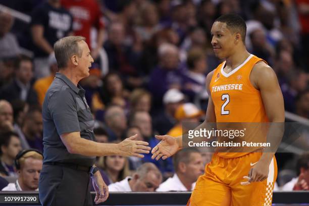 Grant Williams of the Tennessee Volunteers high fives head coach Rick Barnes as he checks out of the second half of the game against the Gonzaga...
