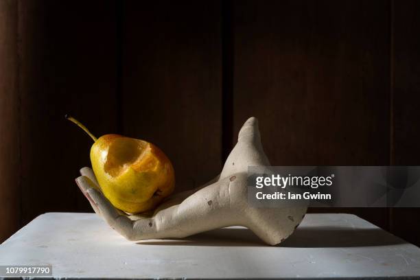 pear in mannequin hand_1 - ian gwinn stock pictures, royalty-free photos & images