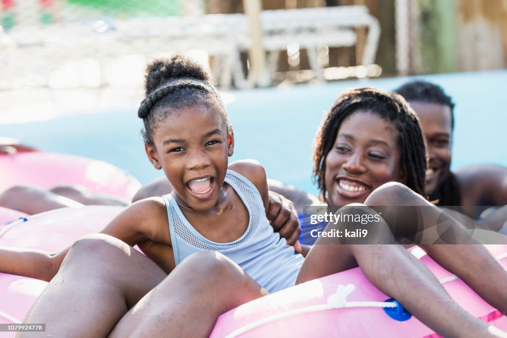 African-American girl, mother on water park lazy river