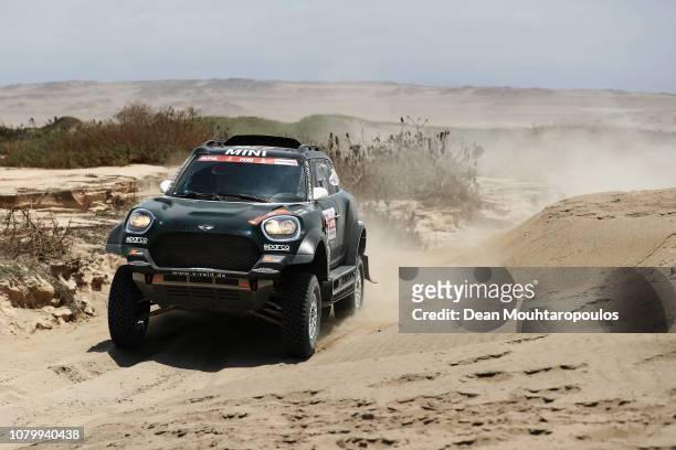 Raid Team no. 307 MINI JOHN COOPER WORKS RALLY car driven by Nani Roma of Spain and Alex Haro Bravo of Spain compete in the near the beach during...