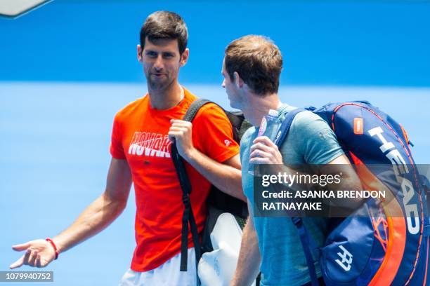 Serbia's Novak Djokovic and Britain's Andy Murray arrive on court during a practice session in Melbourne on January 10 ahead of the Australian Open...