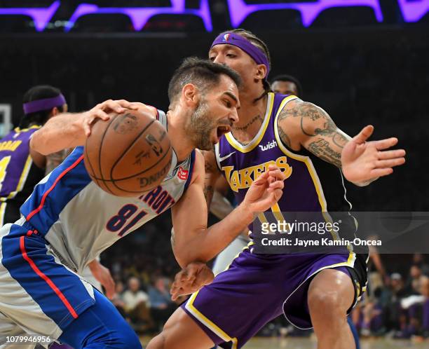 Michael Beasley of the Los Angeles Lakers guards Jose Calderon of the Detroit Pistons as he drives to the basket in the first half of the game at...