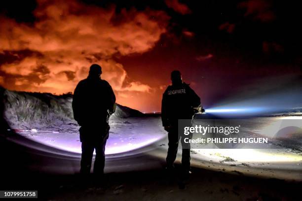 French gendarmes patrol on the beach of Oye-Plage, near Calais, northern France, on January 9, 2019 as they try to intercept migrants attempting to...