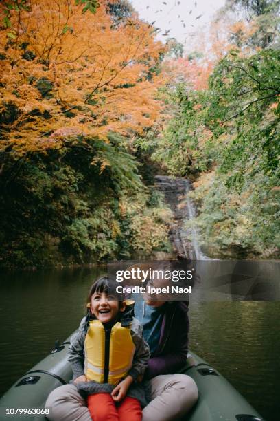 mother and daughter having fun time during river kayaking with fall leaves - kids kayaking stock pictures, royalty-free photos & images