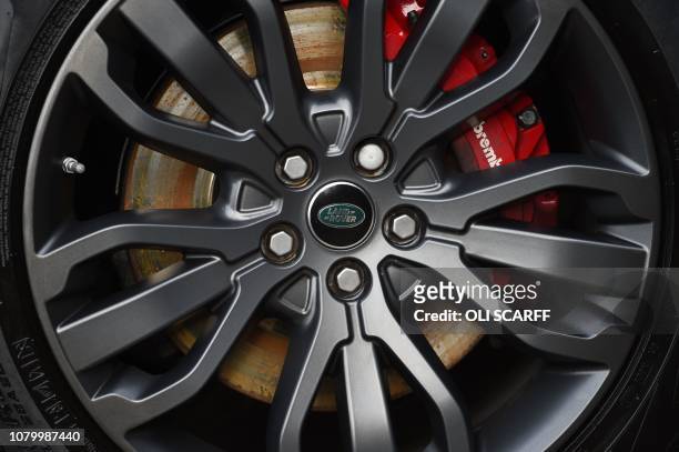 The Land Rover logo is seen on the wheel trim of a Range Rover car at a Land Rover dealership in Wakefield, northern England, on Janaury 10, 2019. -...