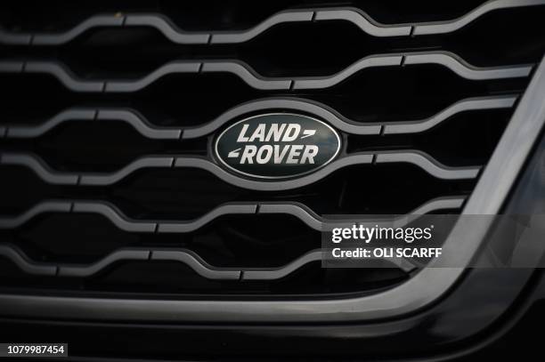 The Land Rover logo is seen on the front of a Range Rover car at a Land Rover dealership in Wakefield, northern England, on Janaury 10, 2019. -...