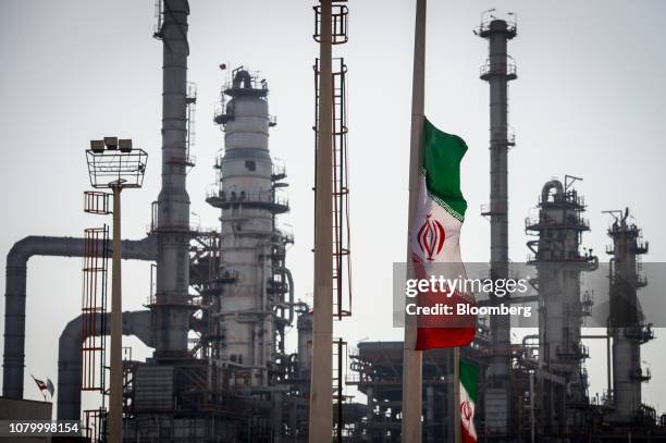 An Iranian national flag flies near gas condensate processing facilities in the new Phase 3 facility at the Persian Gulf Star Co. Refinery in Bandar...