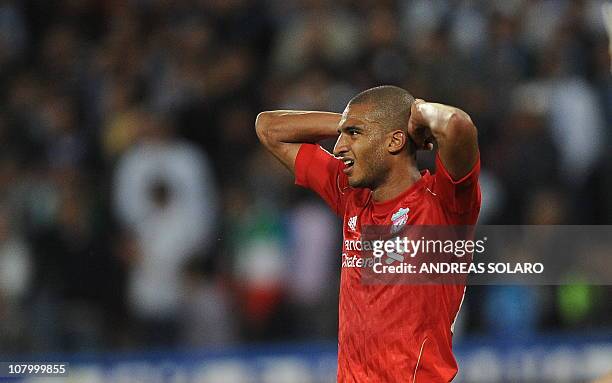 Liverpool's French forward David Ngog reacts after missing a goal opportunity against Napoli during their Europa League football match at San Paolo...