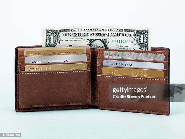 open wallet with credit cards and one dollar bill - brieftasche stock-fotos und bilder