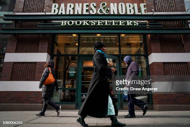 People walk by a Barnes & Noble bookstore, January 10, 2019 in the Brooklyn borough of New York City. On Thursday, Barnes & Noble Inc. Cautioned...