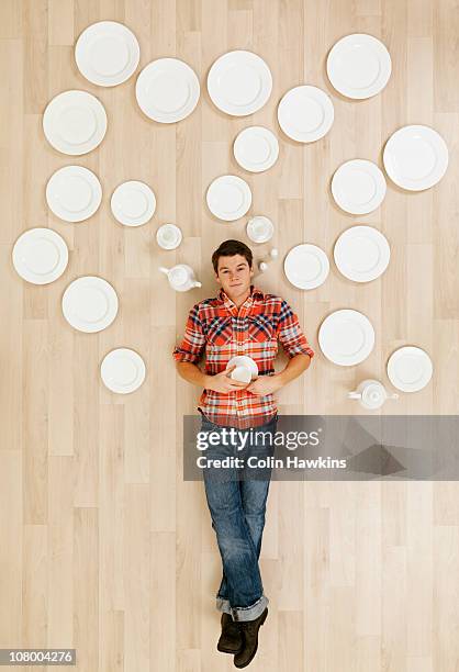 man laying on floor with crockery thought bubbles - lying down top view stock pictures, royalty-free photos & images