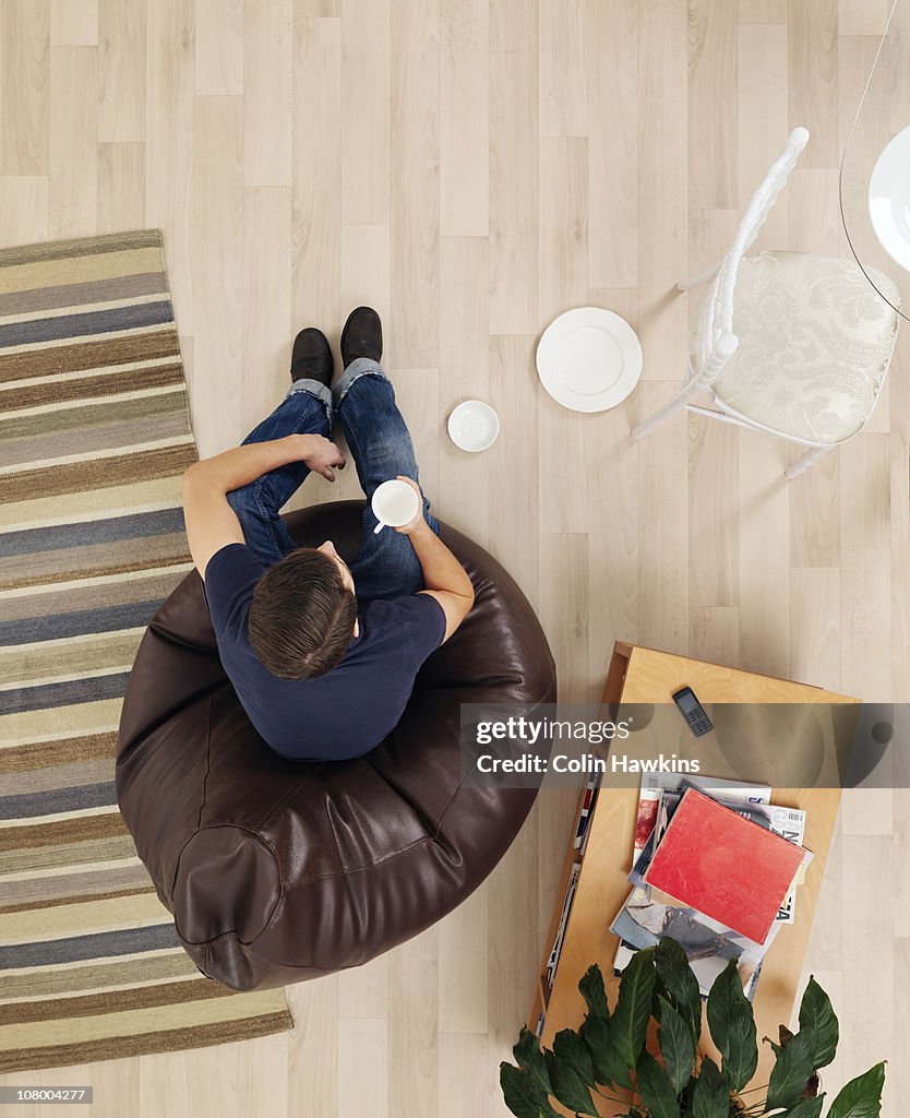 Man sitting in lounge with thought bubbles