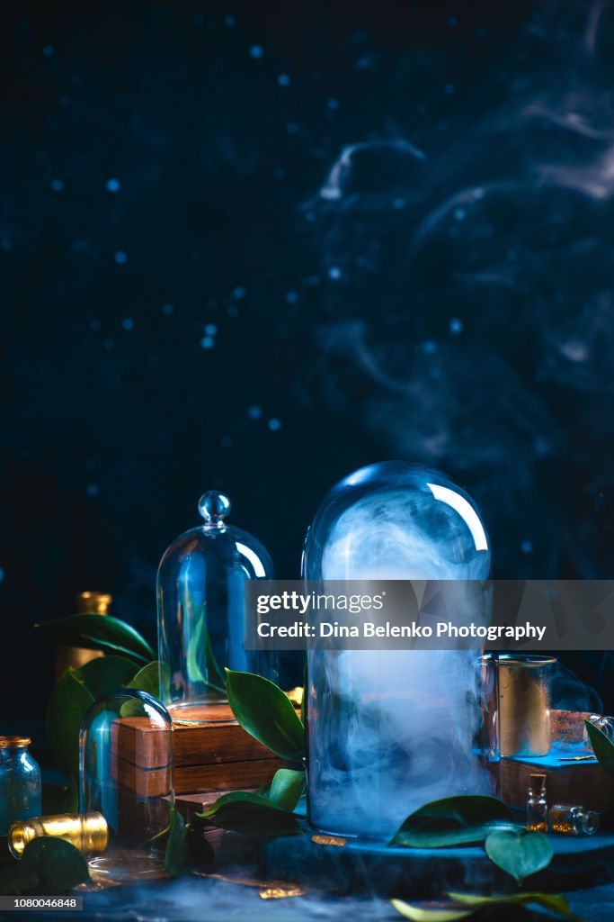 Cloud under a glass dome. Controlling weather concept. Magical still life on a dark background with copy space.