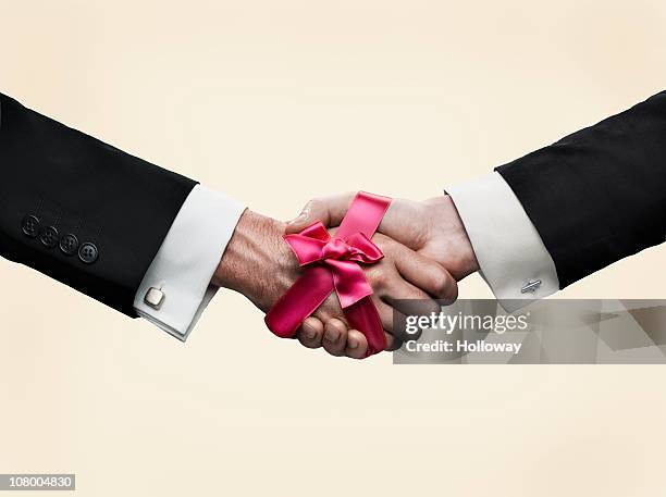 hand shake - hands tied up stock pictures, royalty-free photos & images