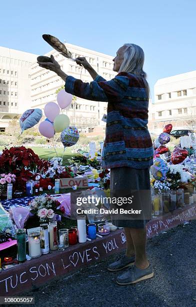 Native American practitioner Carol Locust uses traditional methods to provide healing for the injured at the makeshift memorial for those killed and...