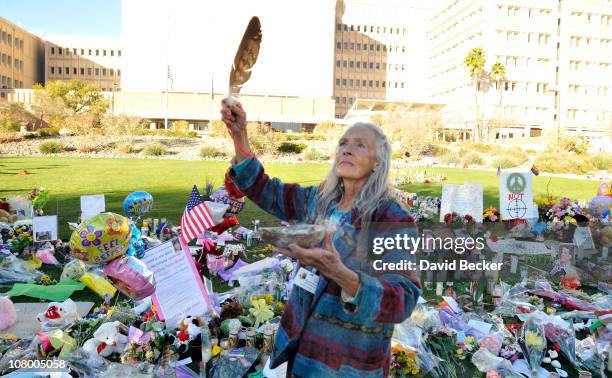 Native American practitioner Carol Locust uses traditional methods to provide healing for the injured at the makeshift memorial for those killed and...