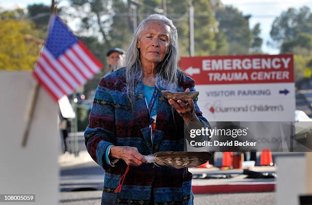 Native American practitioner Carol Locust uses traditional methods to provide healing for the injured at the makeshift memorial for those killed and...