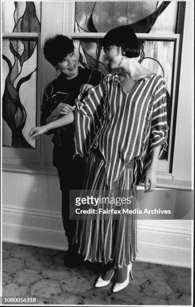 Fashion designer Vivian Chan Shaw and her daughter Claudia, Vivian adjusts dressed modeled by her daughter. August 4, 1986. .