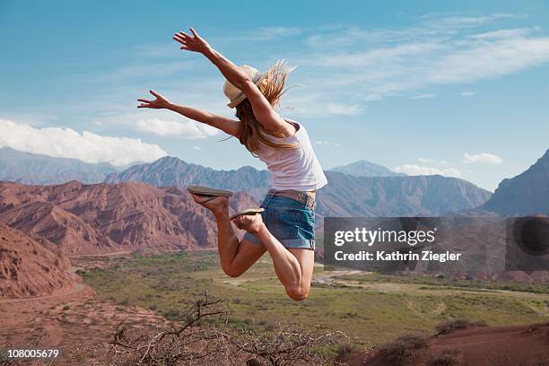woman leaping in mid-air - salta argentina fotografías e imágenes de stock