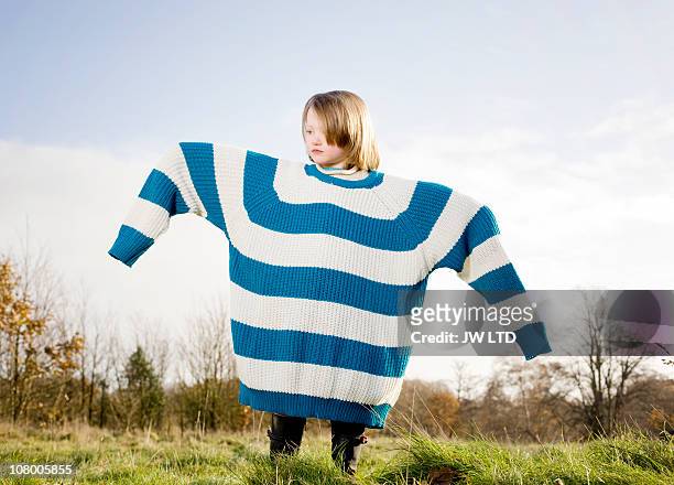 girl wearing oversized jumper, arms out - oversized object stock pictures, royalty-free photos & images