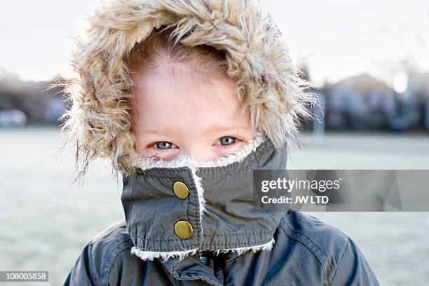 girl wearing parka with mouth covered, portrait - parka cappotto invernale foto e immagini stock