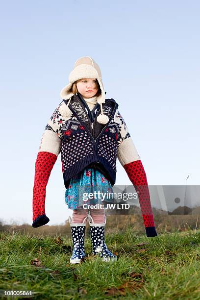 girl wearing oversized wooly jumpers - kid in big shoes stock pictures, royalty-free photos & images