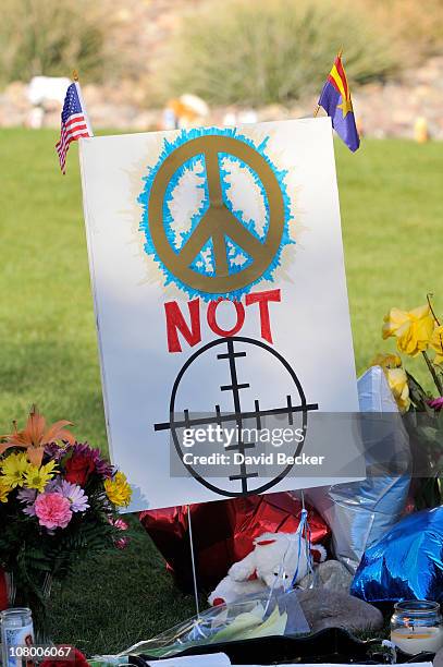 Signs at the makeshift memorial for those killed and wounded during an attack on U.S. Rep. Gabrielle Giffords at the University Medical Center on...