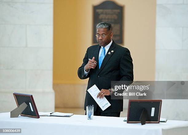 Rep. Allen West, R-Fla., prepares to write in the books well wishes and condolences for Rep. Gabrielle Giffords in the Cannon Rotunda on Wednesday,...