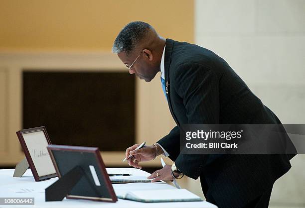 Rep. Allen West, R-Fla., prepares to write in the books well wishes and condolences for Rep. Gabrielle Giffords in the Cannon Rotunda on Wednesday,...