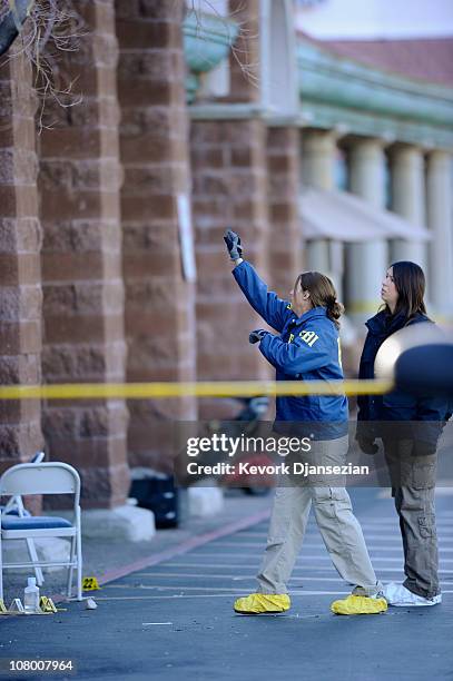 Agents collect evidence from the shooting scene in the La Toscana Village parking lot on January 12, 2011 in Tucson, Arizona. U.S. Rep. Gabrielle...