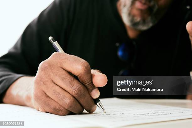 skilled black musician wrote a song made to the paper - form filling fotografías e imágenes de stock