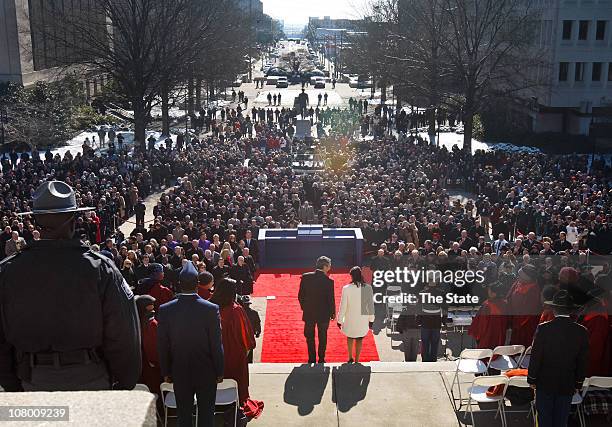 Nikki Haley and Gov. Mark Sanford, left, proceed down the Statehouse steps for her inauguration ceremony as governor of South Carolina, Wednesday,...
