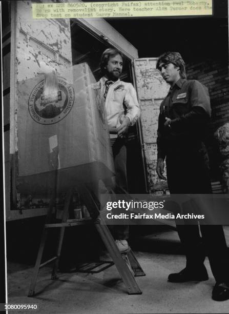 Here teacher Alan Turner does the drop test on student Garry Mannel.School of Furniture Removalists.Packing and drop test. A major test of skill for...