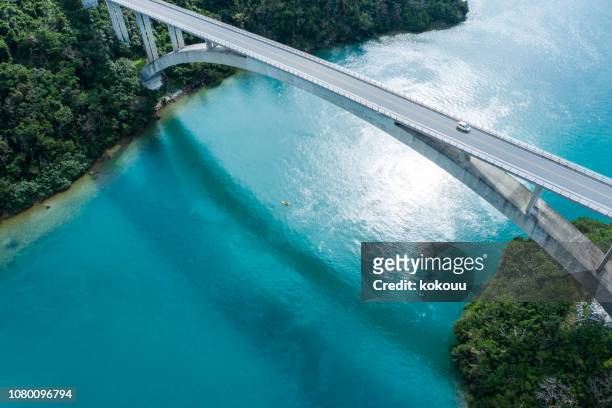 aerial photograph of the beautiful sea and bridge. - okinawa blue sky beach landscape stock pictures, royalty-free photos & images