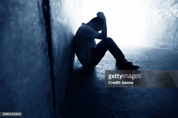desperate man sitting in the tunnel - solitude stock pictures, royalty-free photos & images
