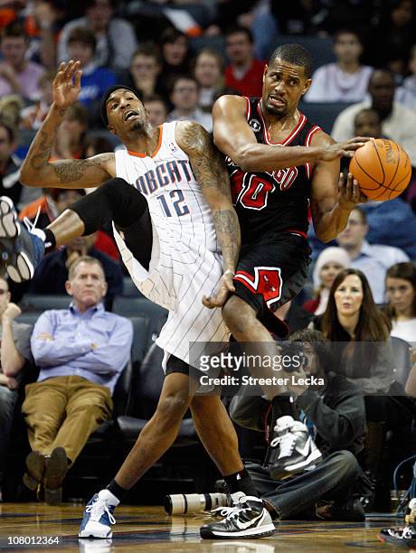 Kurt Thomas of the Chicago Bulls battles for a loose ball with Tyrus Thomas of the Charlotte Bobcats during their game at Time Warner Cable Arena on...