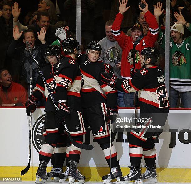Jack Skille of the Chicago Blackhawks is congratulated by Duncan Keith, Viktor Stalberg and Jack Dowell after scoring a goal in the 3rd period...