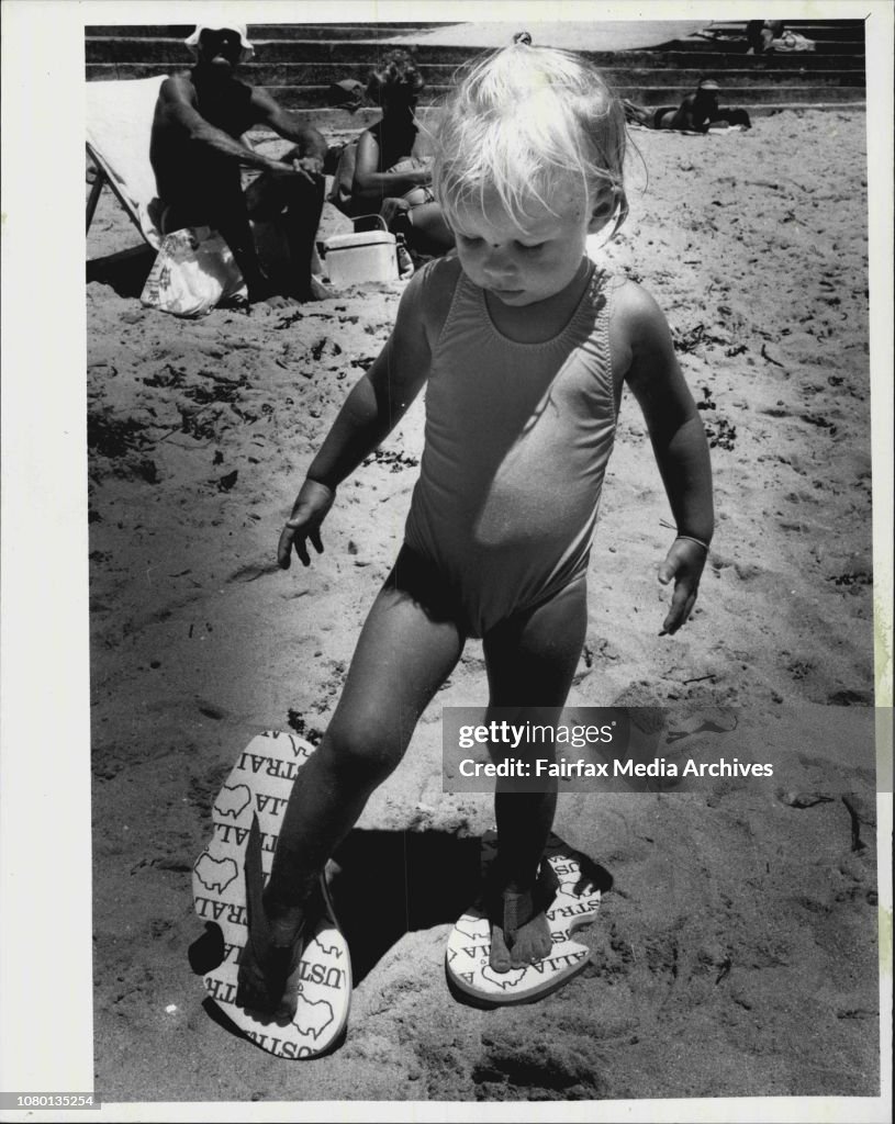 Two Year old Cassie Waters of Dee why with Australian shaped thongs.This object is called an Auzzie Thong, which its manufacturers hope will take Australia's feet by storm.The thong, along with the Esky, teh stump-jump plough and the rotary clothes-hoist,