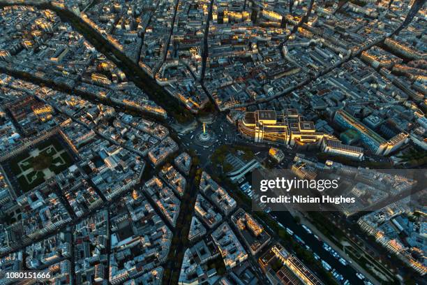 aerial flying over la bastille in paris france, sunset - bastille paris stock-fotos und bilder