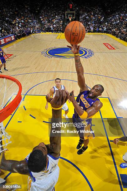 Kobe Bryant of the Los Angeles Lakers attempts a hook shot over Dorell Wright of the Golden State Warriors on January 12, 2011 at Oracle Arena in...