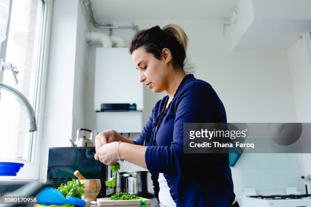A woman cooking in her kitchen