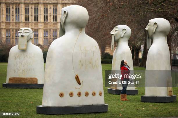Woman admires a series of sculptures entitled 'Nuestros Silencios' by Mexican artist Rivelino are installed in Victoria Tower Gardens on January 13,...