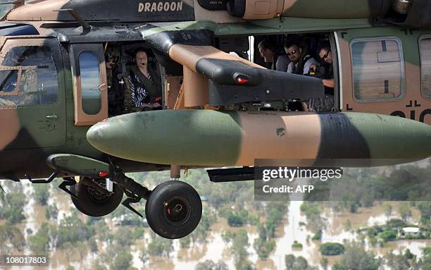 Australian Prime Minister Julia Gillard flies in an army Blackhawk helicopter to view the flooded Fitzroy River in Rockhampton on January 8, 2011....