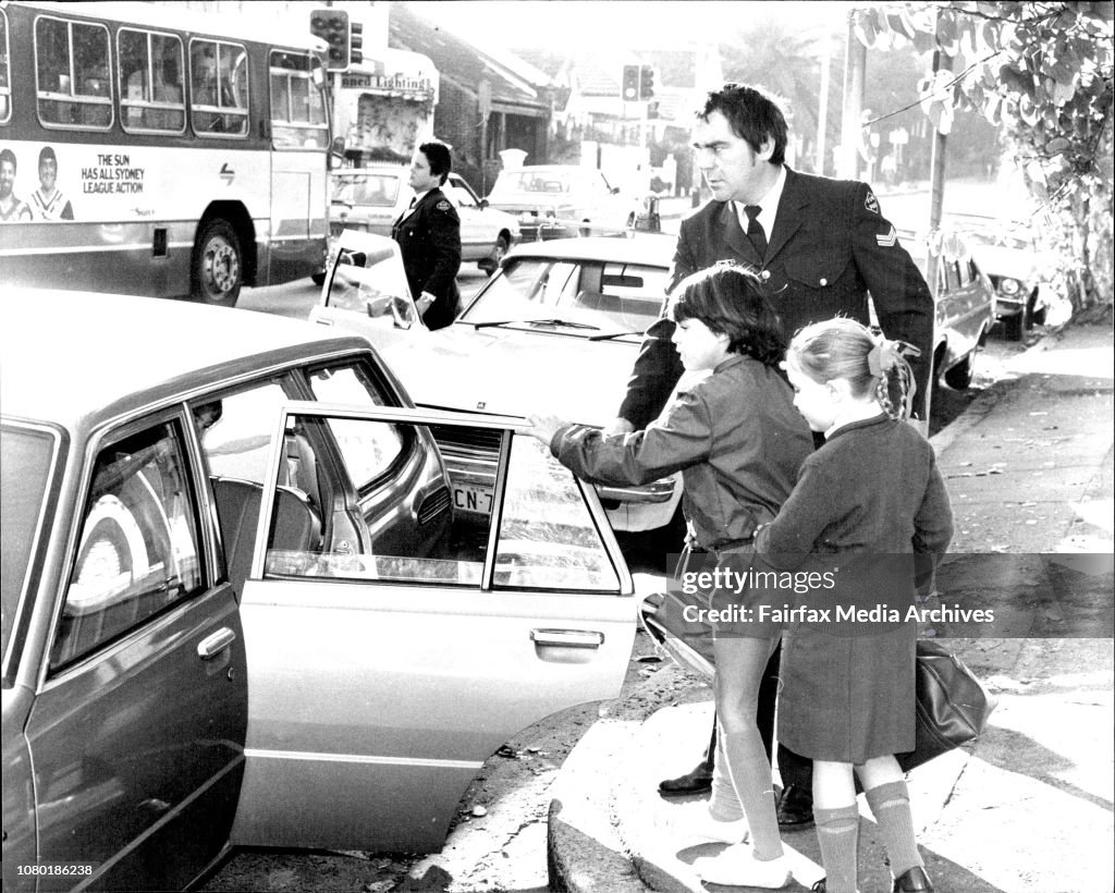 The children of murdered judge Mr. Justice Opas are taken by a police office to a friends car, they were dressed ready for school.Children Joshua, 6 and Persia, 8.