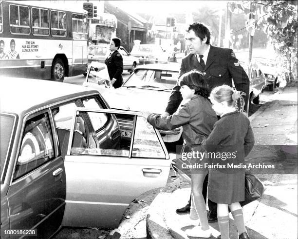 The children of murdered judge Mr. Justice Opas are taken by a police office to a friends car, they were dressed ready for school.Children Joshua, 6...